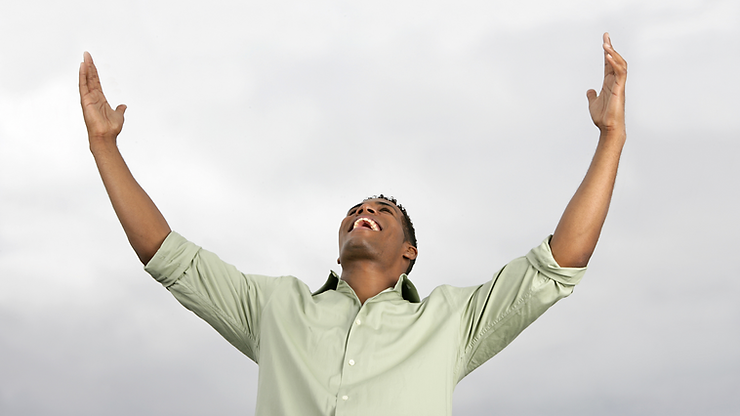 A man looking upwards while exclaiming in joy.