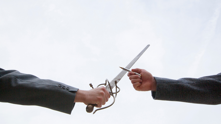 An image of a sword clashing with a pen.