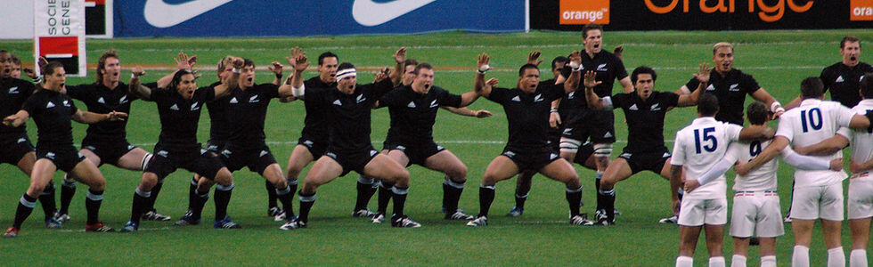 An image of the New Zealand All Blacks team performing a pre-game Haka