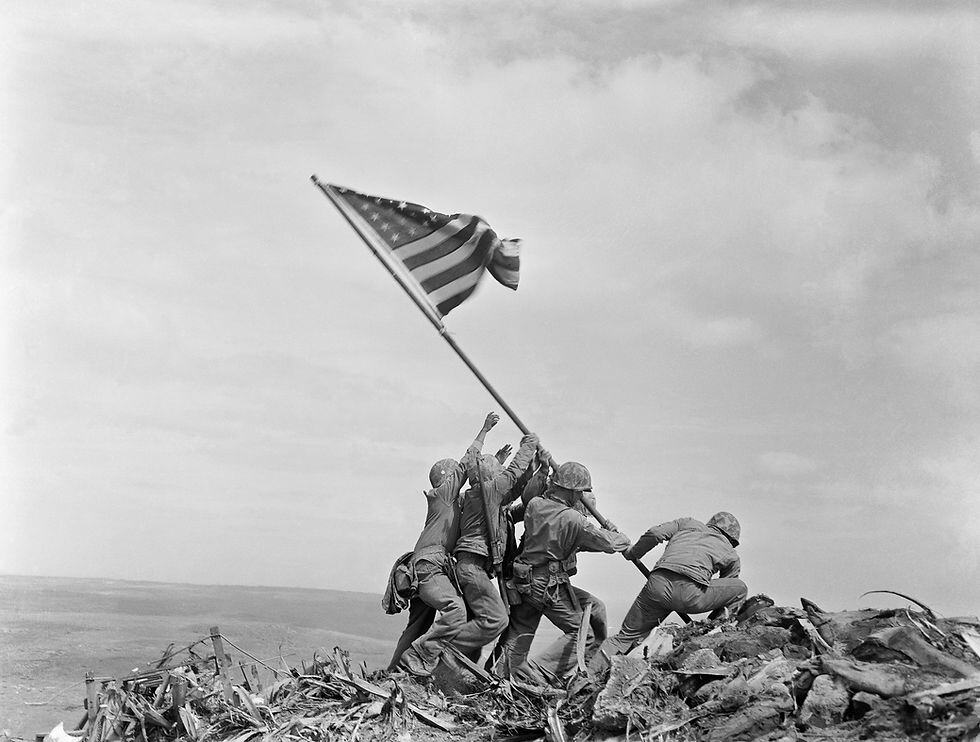 Iconic photo taken during the Battle of Iwo Jima with soldiers raising a US flag. You can read more about this photograph here: https://en.wikipedia.org/wiki/Raising_the_Flag_on_Iwo_Jima